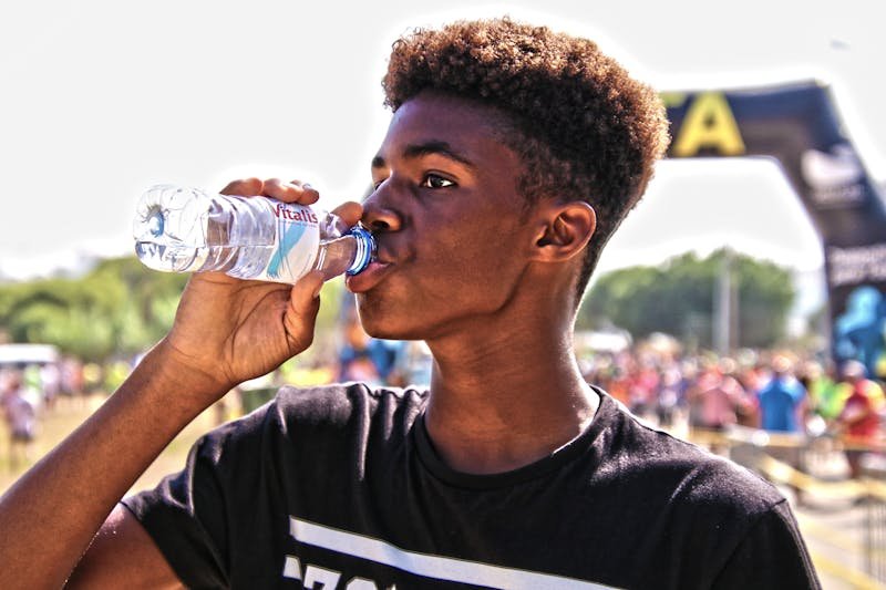 Athlete drinking water for hydration and recovery